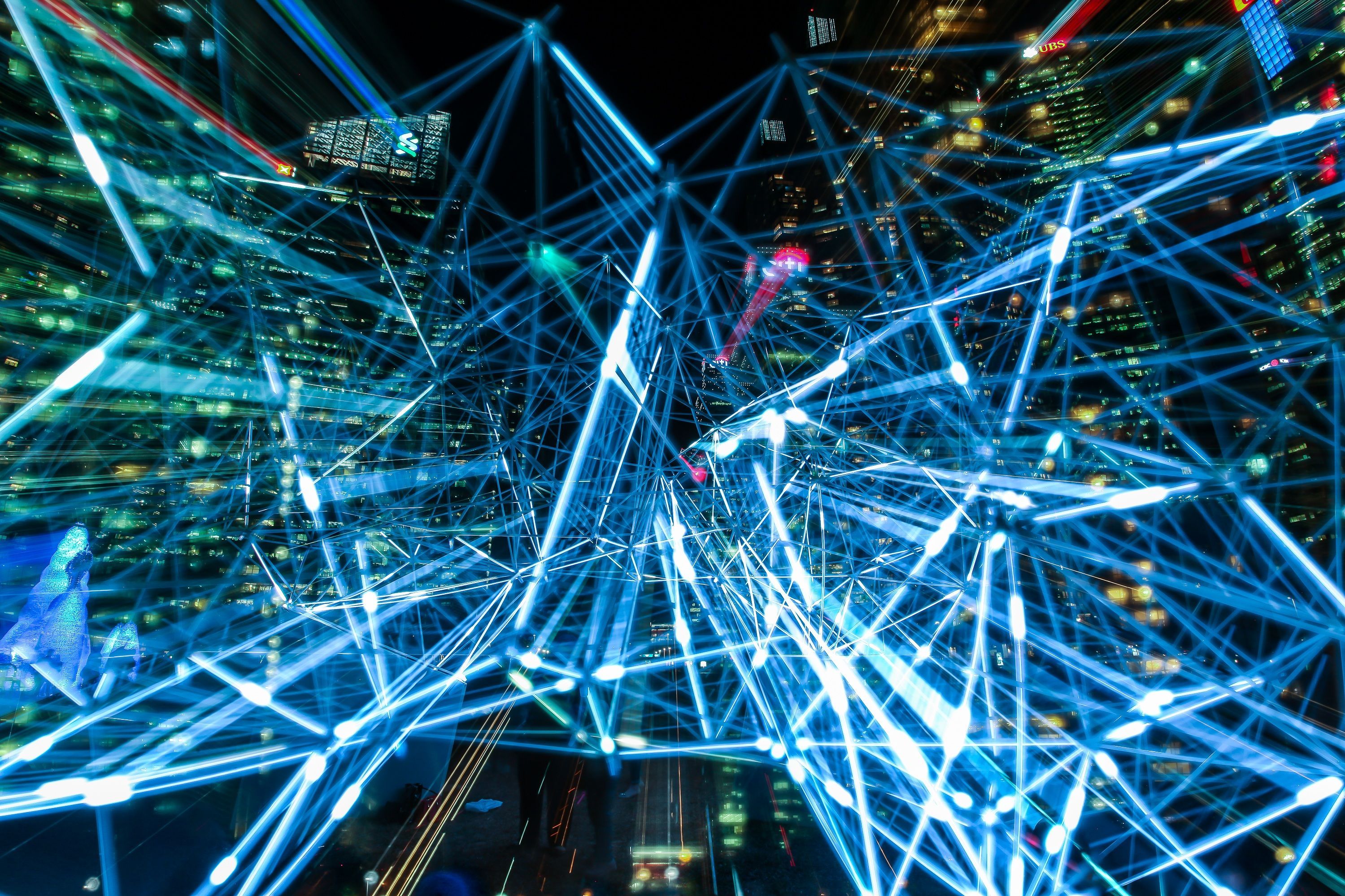 Light trails forming a network above a city at night.