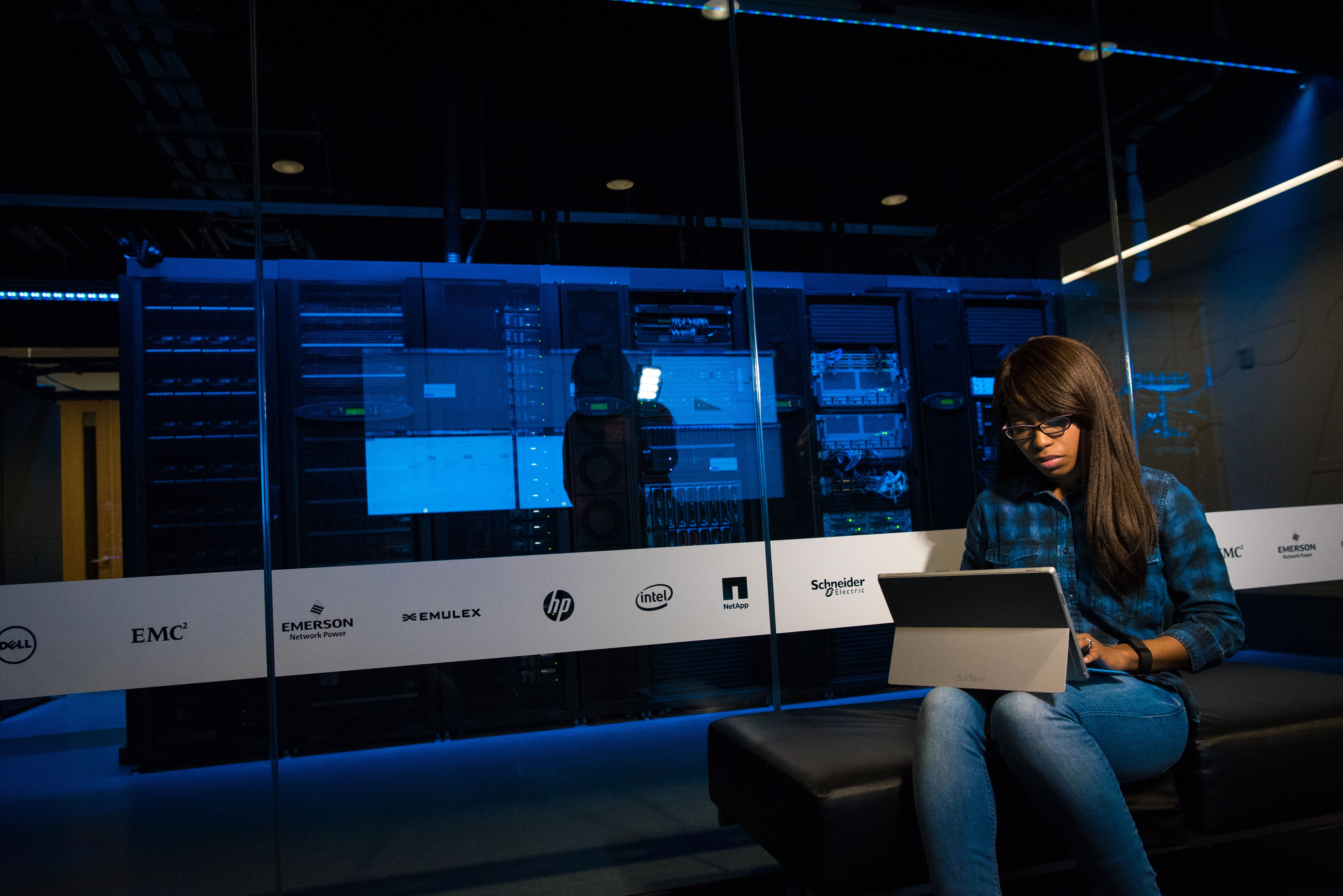 Operators monitoring a wall of live analytical displays.