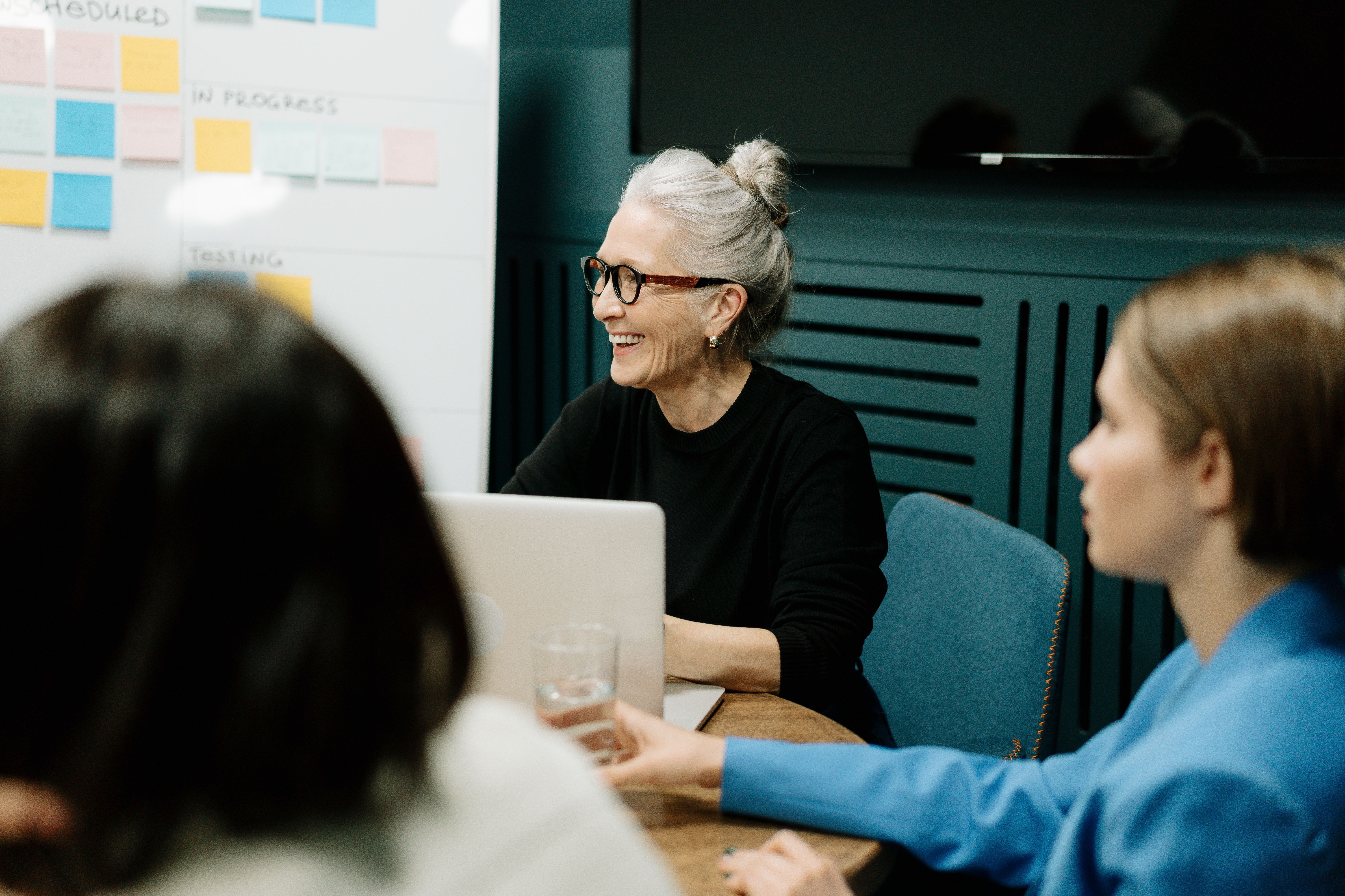 Executives in a workshop session around a wall of planning material.