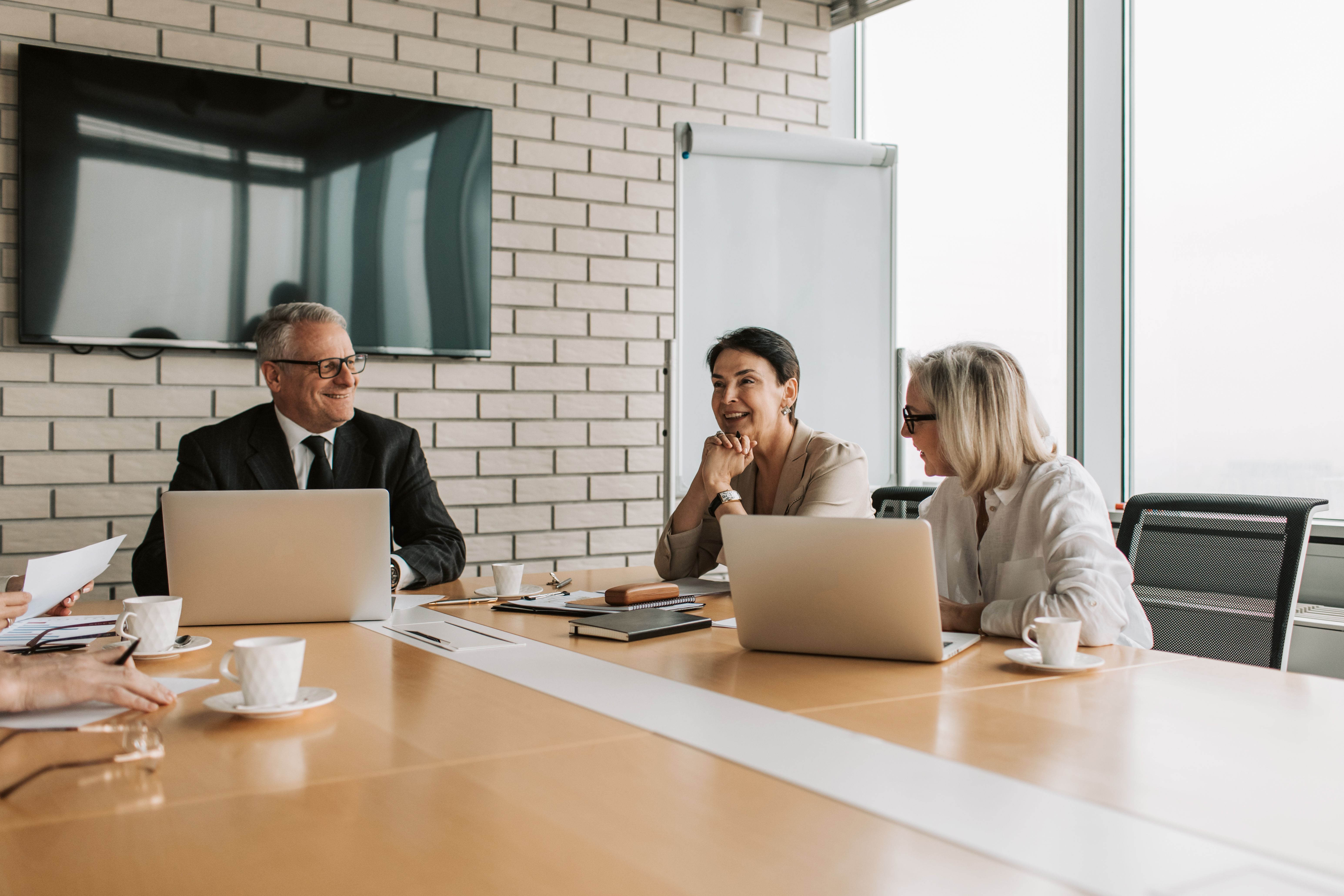 A management team working through material in a meeting room.