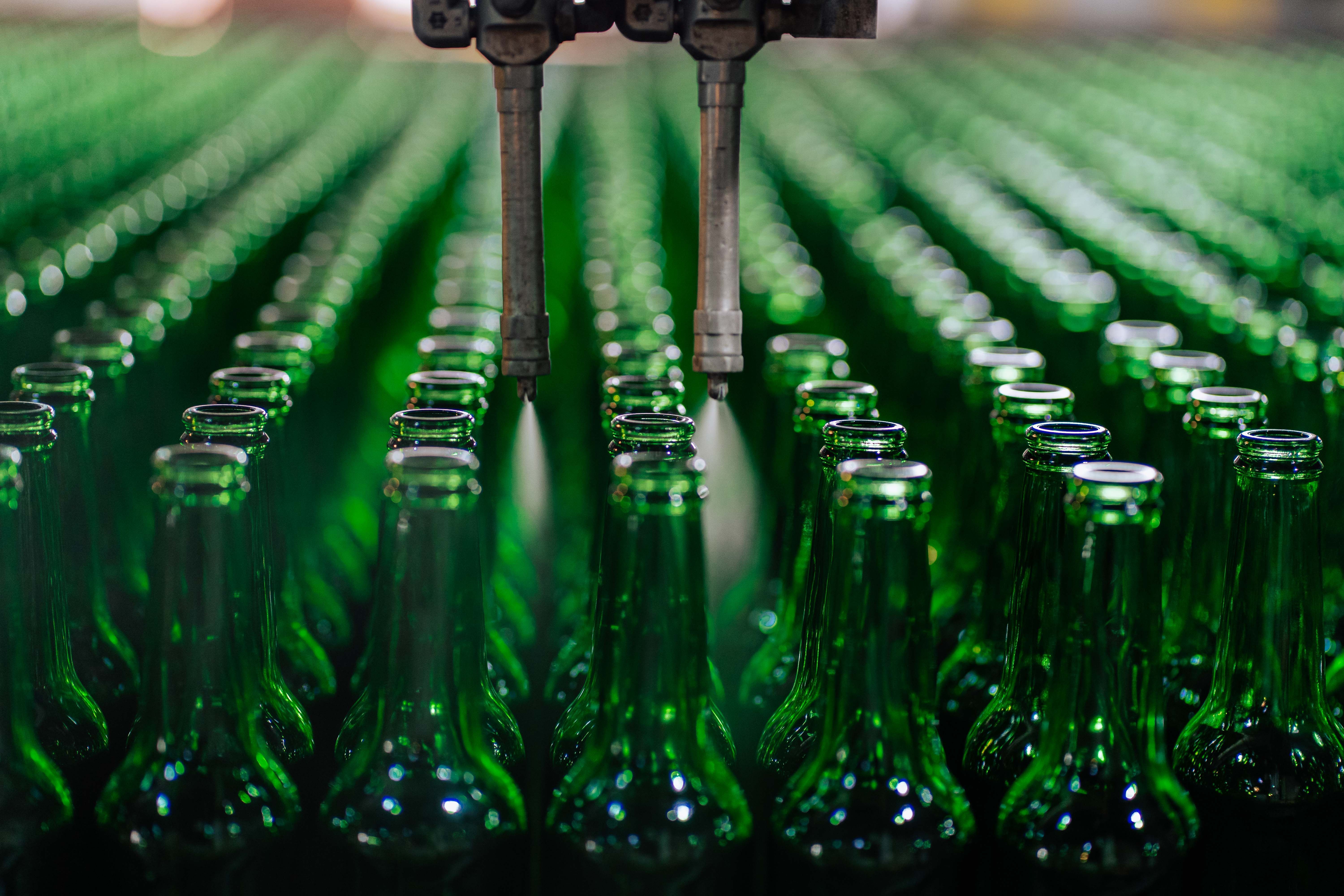 A high-speed bottling line running under production lighting.