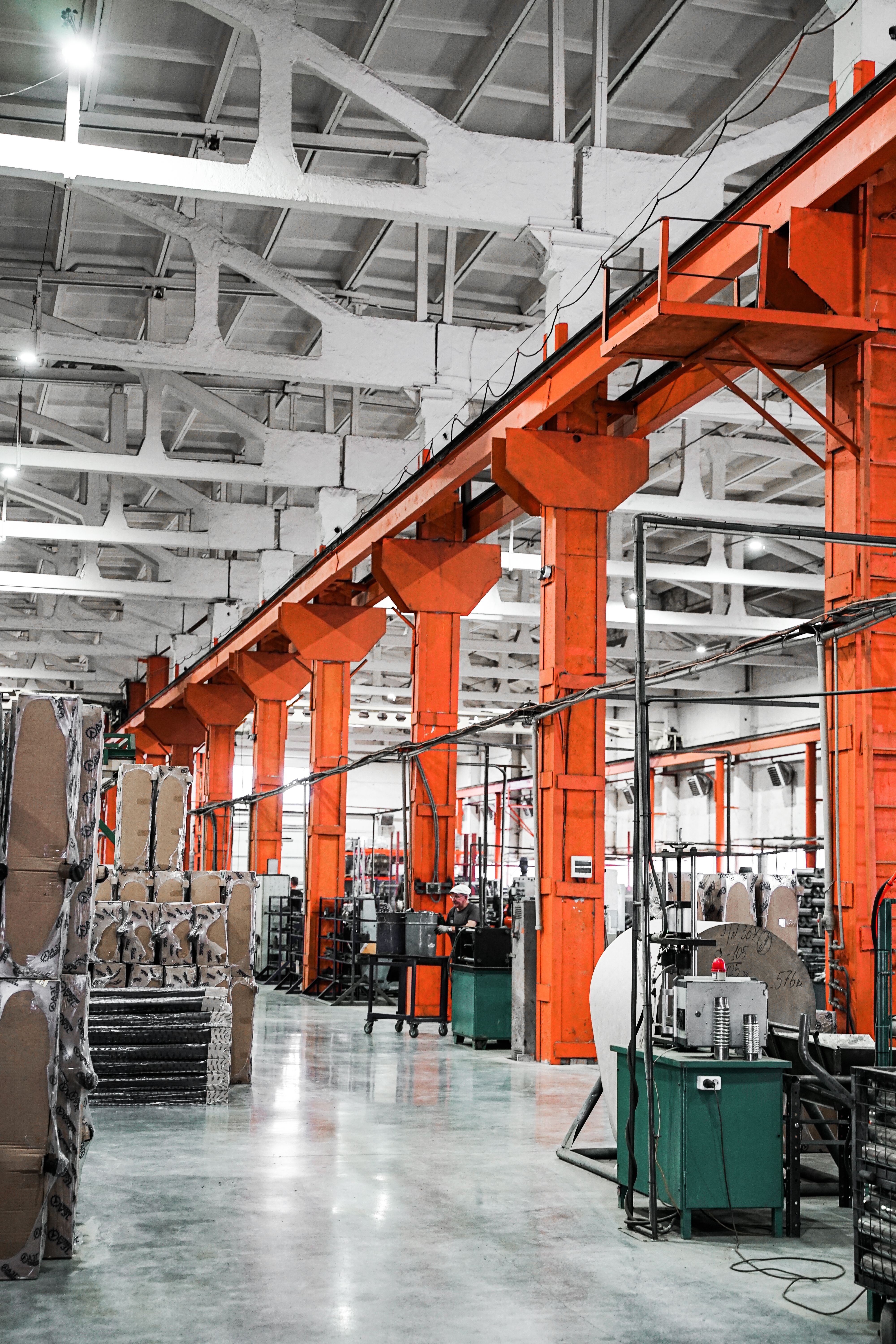 A long factory floor with structural columns receding into the distance.