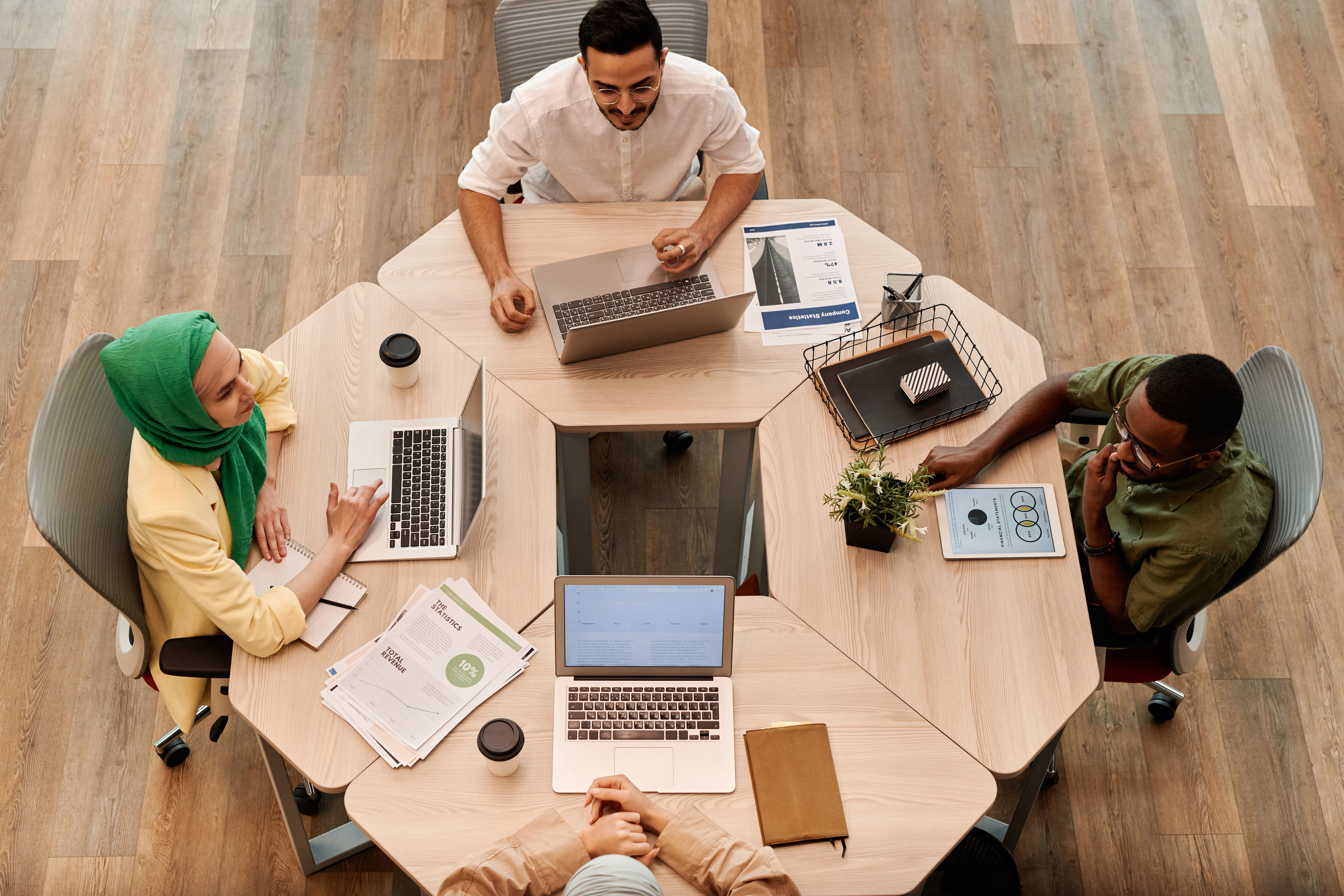 An overhead view of a team working around a round table.
